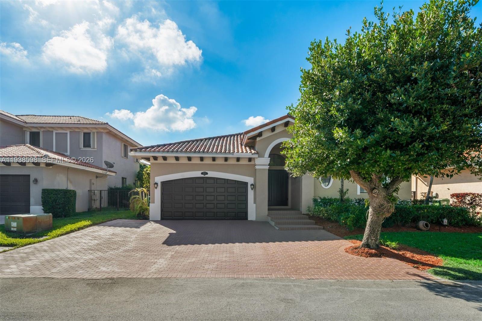 7548 Southwest 190th Street Cutler Bay, FL 33157 - Photo 3 of 53 a front view of a house with garden