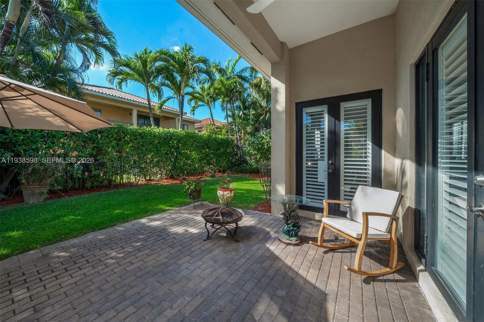 7548 Southwest 190th Street Cutler Bay, FL 33157 - Photo 37 of 53 a view of a patio with chair and table back yard of the house
