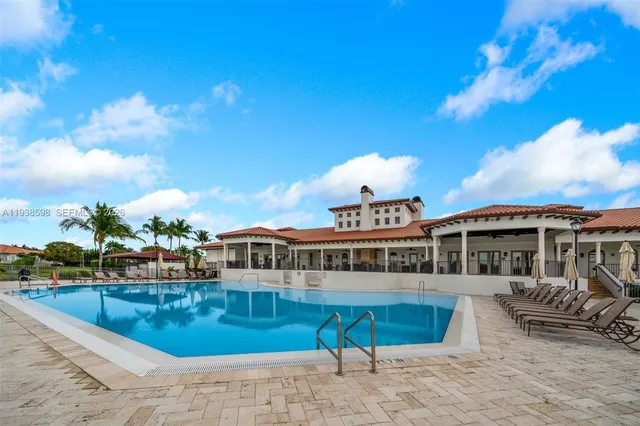 a view of a room with gym equipment and wooden floor
