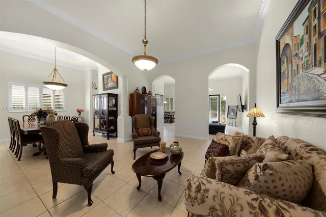 a living room with furniture and a chandelier