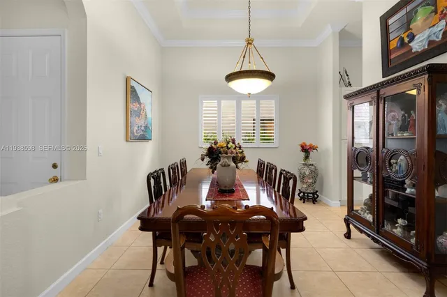 a view of a dining room with furniture and a chandelier