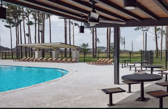 a view of a patio with a table chairs and wooden fence