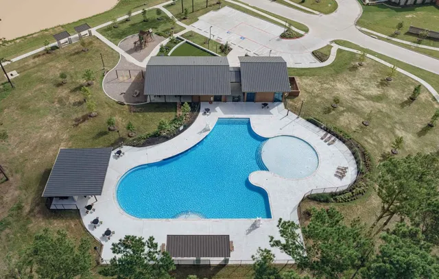 an aerial view of a house with swimming pool and outdoor seating