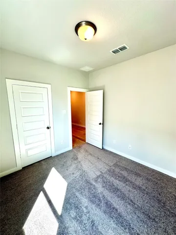 an empty room with a window and closet