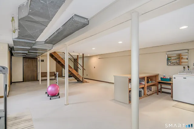 a backyard of a house with barbeque oven and outdoor seating