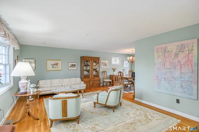 a living room with furniture a lamp and a table