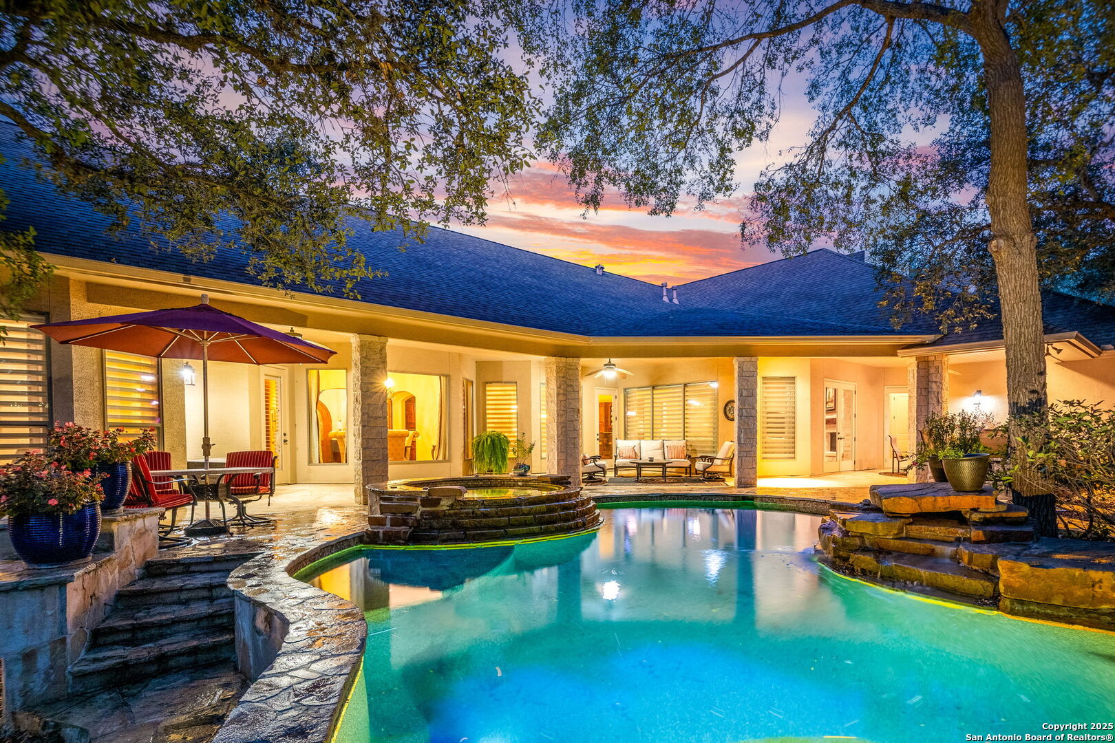 a view of a swimming pool with couches and lounge chairs