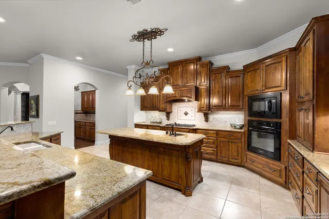 a bathroom with a granite countertop shower a toilet and a sink