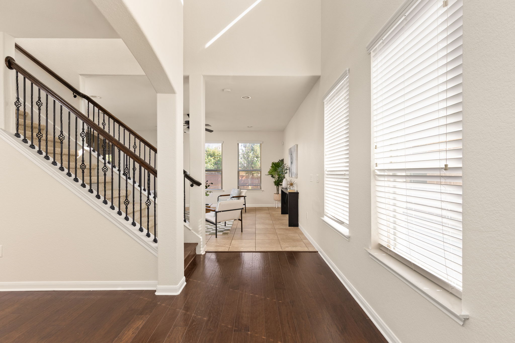 2400 Leonards Pass Leander, TX 78641 - Photo 5 of 40 A well-lit entry hall with rich hardwood floors and an elegant staircase.