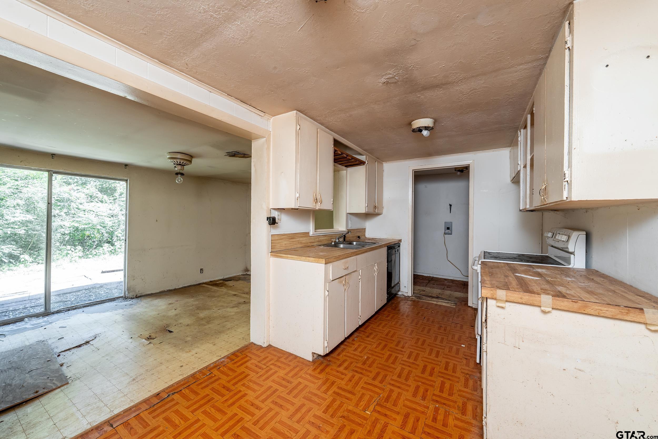 13174 County Road 434 Lindale, TX 75771 - Photo 14 of 32 a kitchen with a refrigerator a stove top oven and a large window