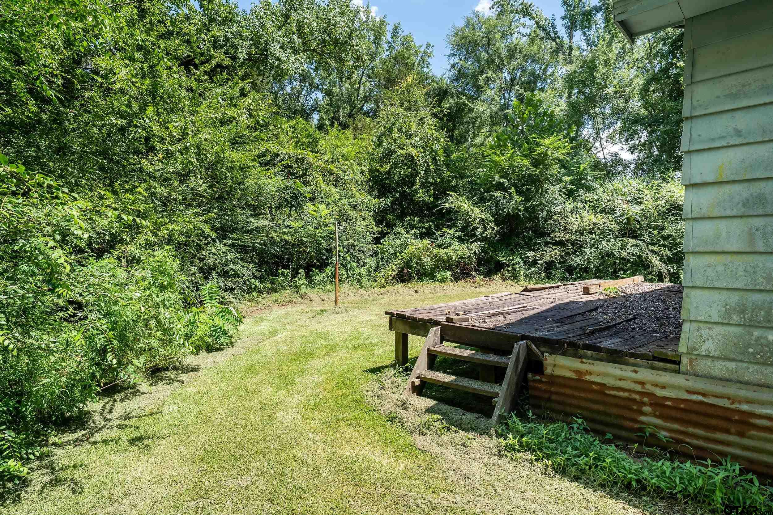 13174 County Road 434 Lindale, TX 75771 - Photo 9 of 32 a wooden bench sitting in the middle of a yard