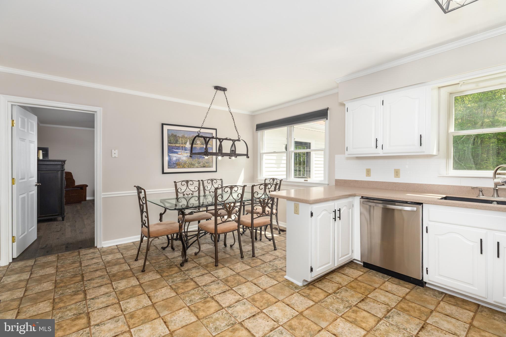 35588 Lizzard Hill Road Frankford, DE 19945 - Photo 12 of 39 a kitchen with a dining table chairs and white cabinets