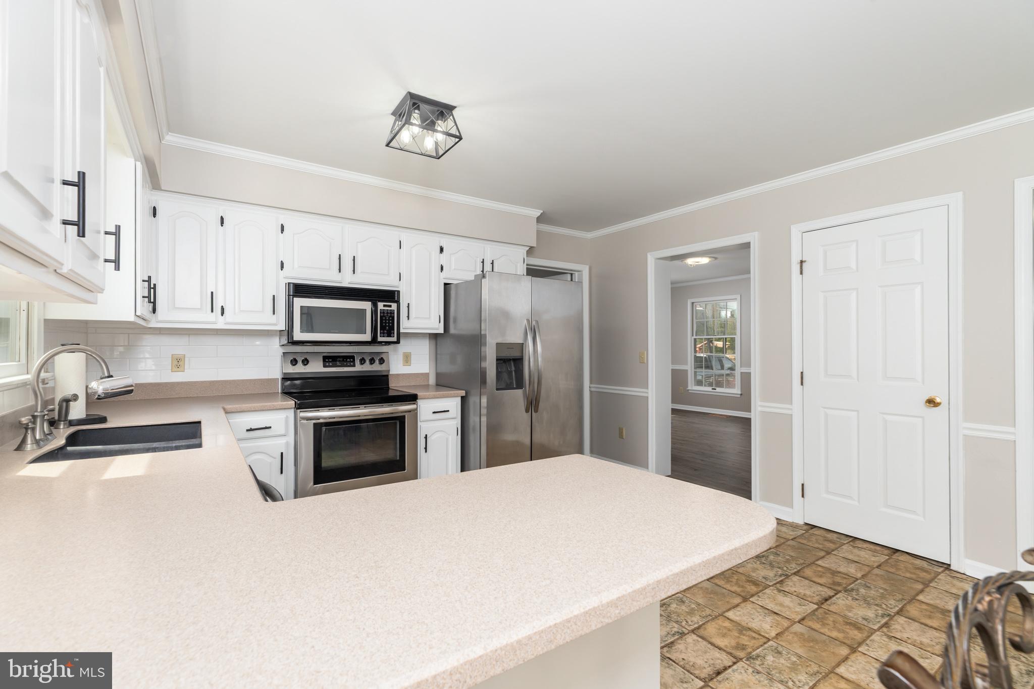 35588 Lizzard Hill Road Frankford, DE 19945 - Photo 13 of 39 a kitchen with stainless steel appliances a stove sink and refrigerator