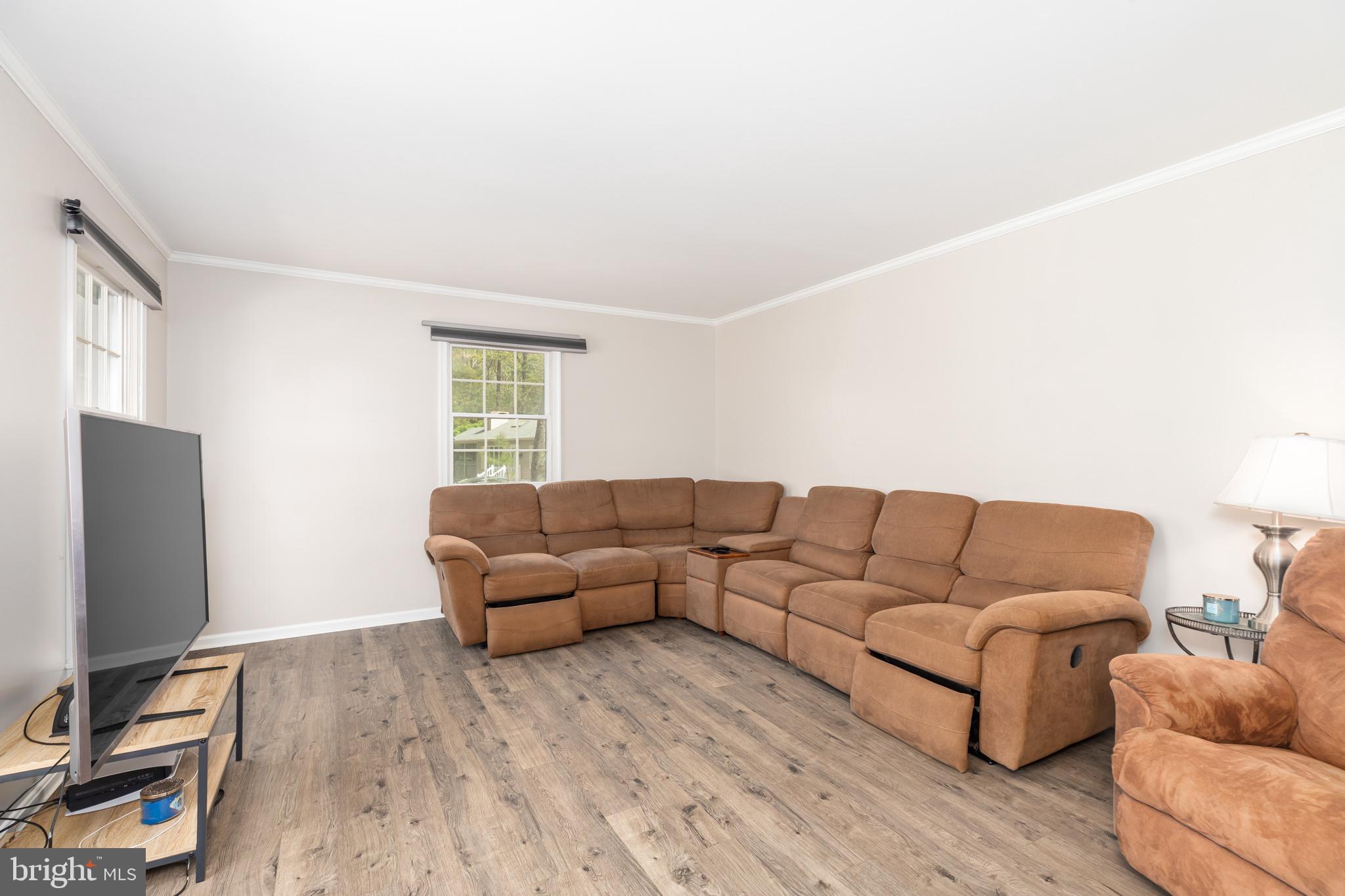 35588 Lizzard Hill Road Frankford, DE 19945 - Photo 15 of 39 a living room with furniture a flat screen tv and a window