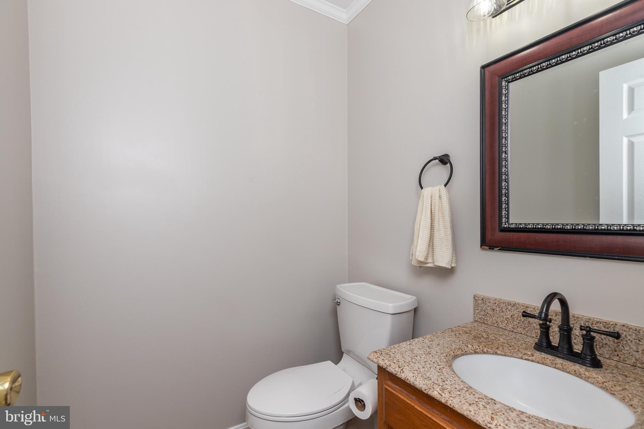 35588 Lizzard Hill Road Frankford, DE 19945 - Photo 24 of 39 a bathroom with a toilet sink and mirror