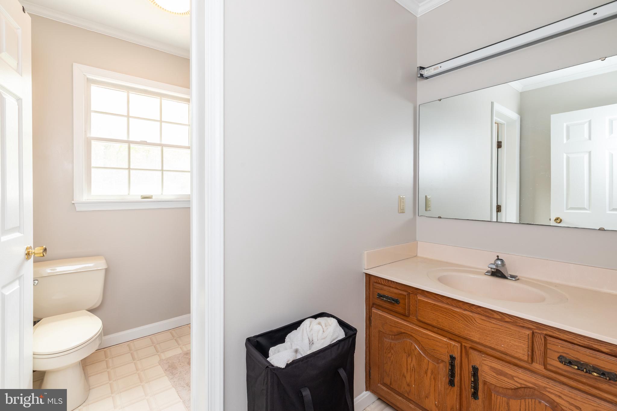 35588 Lizzard Hill Road Frankford, DE 19945 - Photo 33 of 39 a bathroom with a toilet sink and mirror