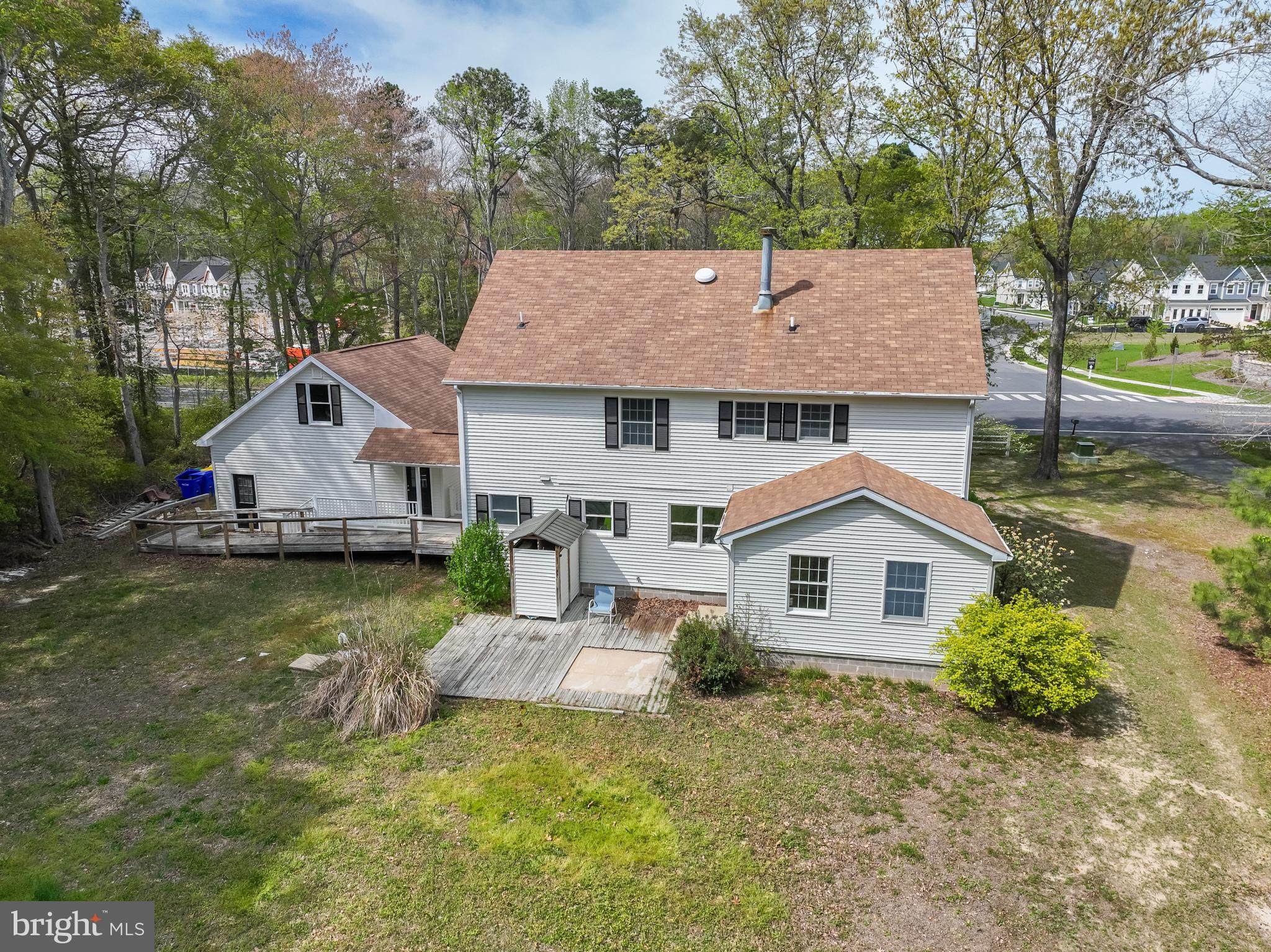 35588 Lizzard Hill Road Frankford, DE 19945 - Photo 4 of 39 a aerial view of a house next to a yard with potted plants and large tree