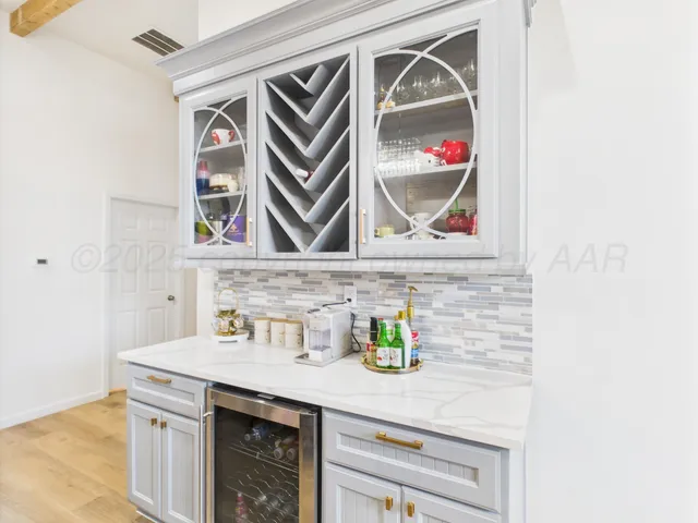 a utility room with a sink and cabinets