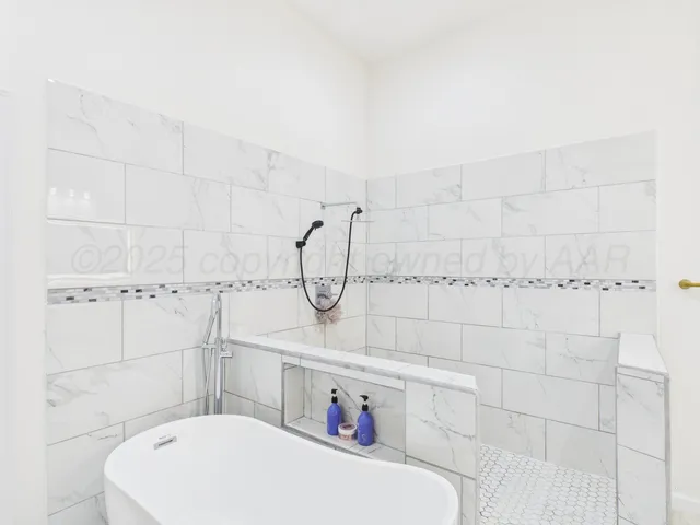 a bathroom with a window and a shower