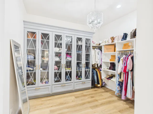 a view of a big room with windows and furniture