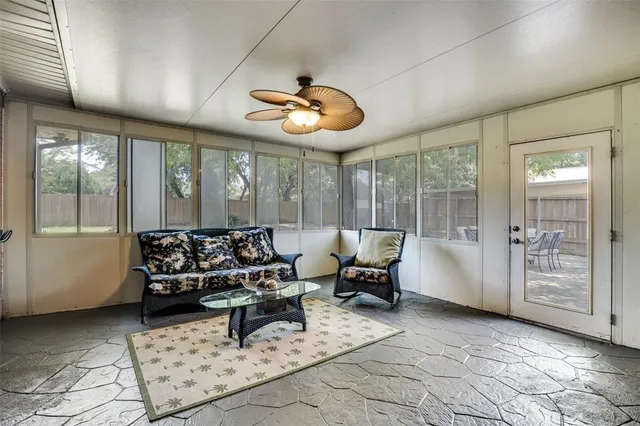 a living room with furniture and large windows