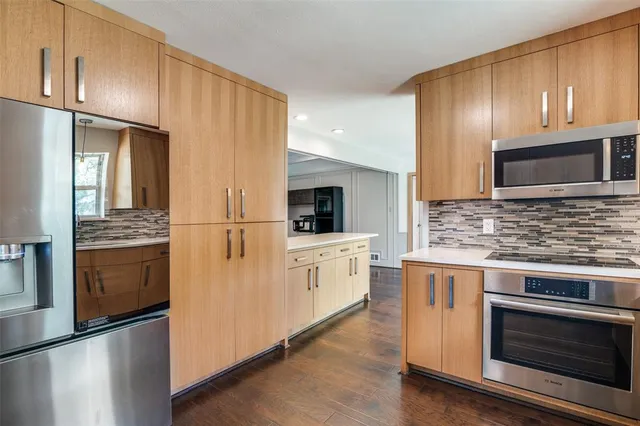 a kitchen with granite countertop stainless steel appliances and cabinets