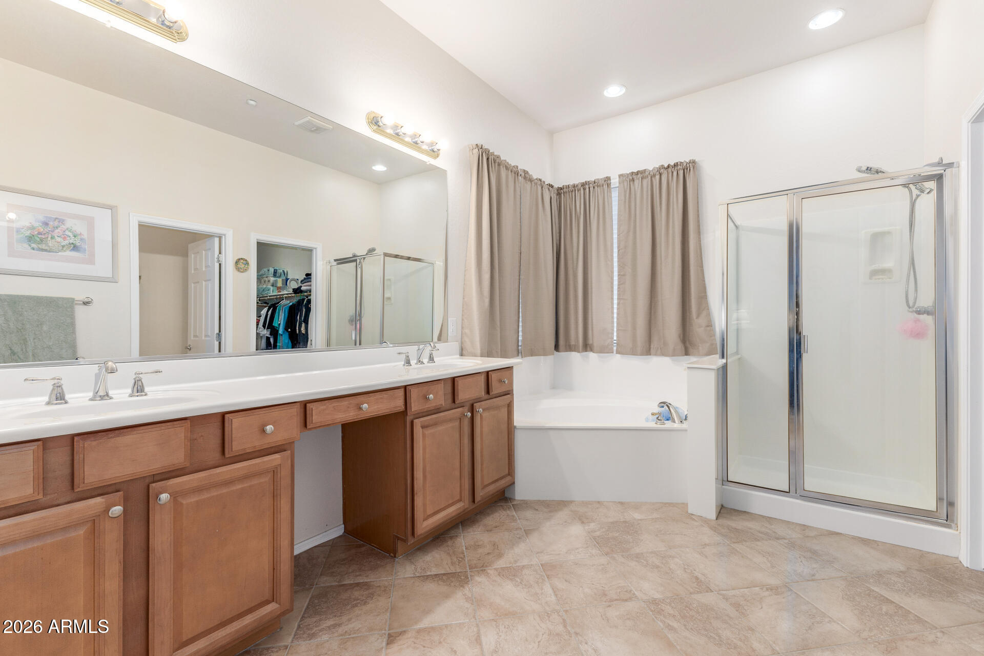12731 West Eagle Ridge Lane Peoria, AZ 85383 - Photo 17 of 88 a spacious bathroom with a mirror a double vanity sink and bathtub