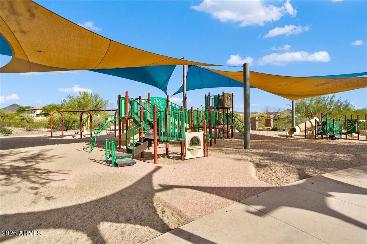 12731 West Eagle Ridge Lane Peoria, AZ 85383 - Photo 53 of 88 a view of a patio with a table and chairs under an umbrella