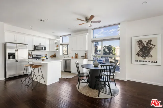 a view of a dining room with furniture and a potted plant