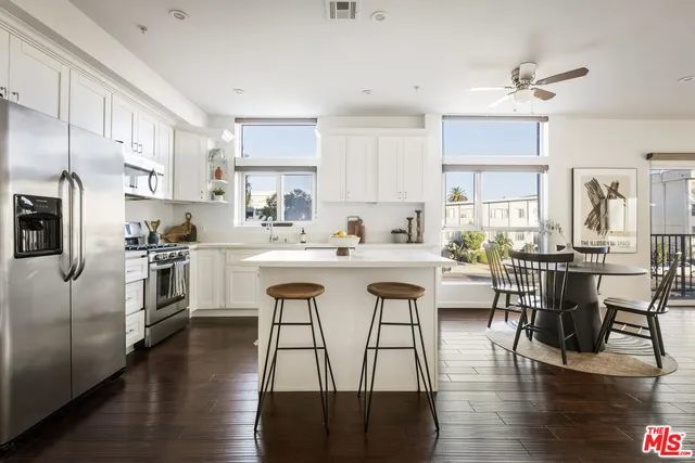 a kitchen with stainless steel appliances granite countertop a sink stove and cabinets