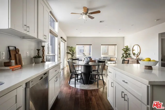 a kitchen with cabinets stainless steel appliances a sink and a microwave