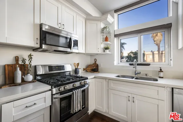 a bedroom with a bed and a potted plant