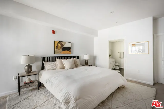 a bedroom with a bed and a potted plant
