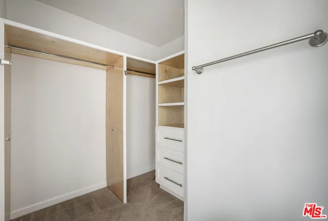 a bedroom with a bed and a walk in closet