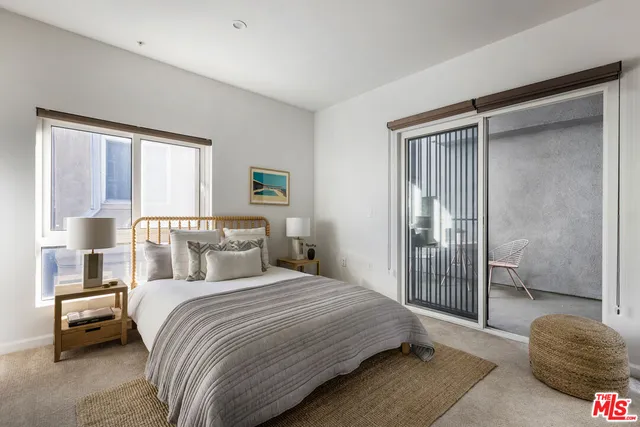 a bedroom with a bed and a mirror