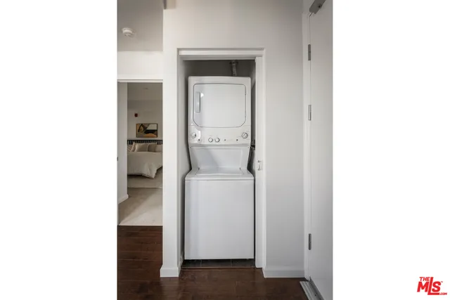 an empty room with a bench and wooden floor