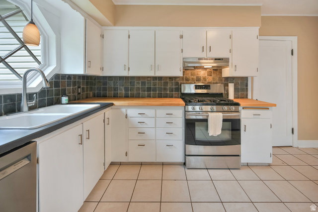 250 West 100 North Logan, UT 84321 - Photo 9 of 41 Kitchen with stainless steel appliances, tasteful backsplash, white cabinets, butcher block countertops