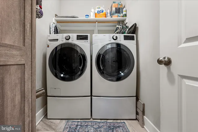 a view of a white house with a yard and large tree