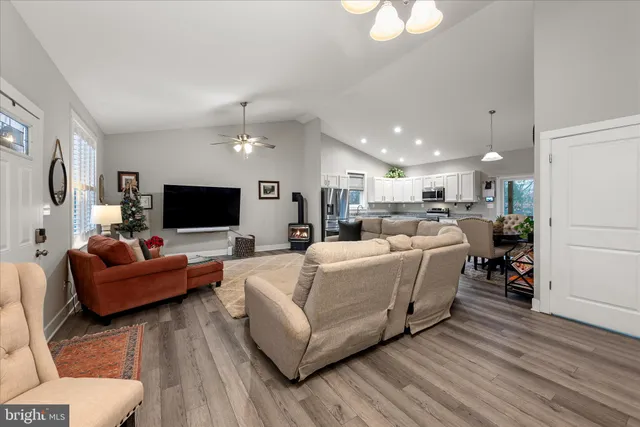 a kitchen with stainless steel appliances granite countertop a refrigerator a stove microwave and cabinets