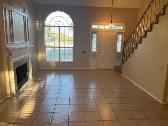 a view of empty room with a fireplace and windows