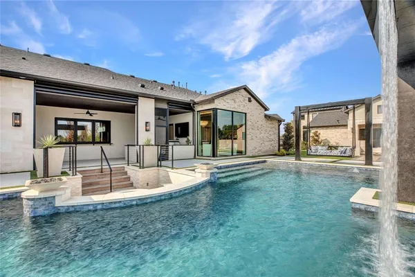 a view of a house with swimming pool and sitting area