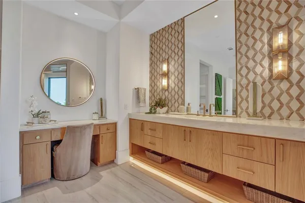 a spacious bathroom with a double vanity sink and a mirror