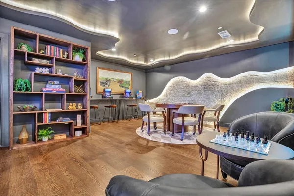 a living room with lots of furniture and a book shelf