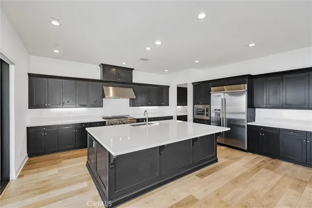 a large kitchen with stainless steel appliances granite countertop a sink counter space and cabinets