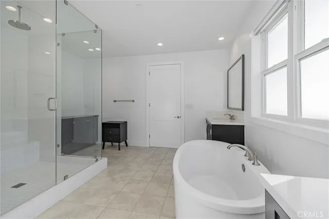 a spacious bedroom with a bed and a large window