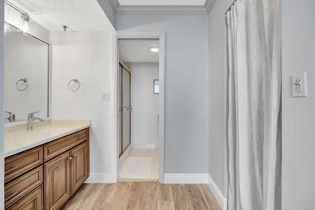 a bathroom with a sink a mirror and a shower