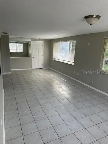 a view of an empty room with windows