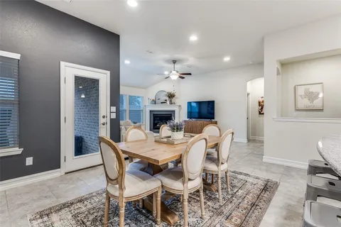 a dining room with furniture and wooden floor