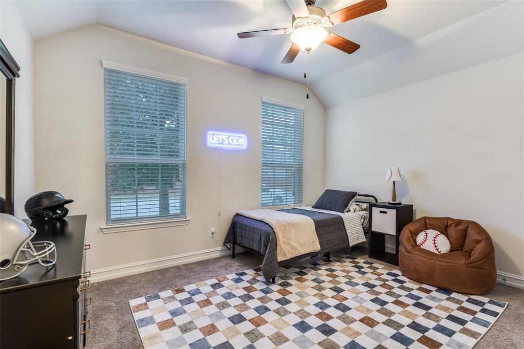 413 Yellowstone Drive Celina, TX 75009 - Photo 18 of 33 a bedroom with a bed and wooden floor