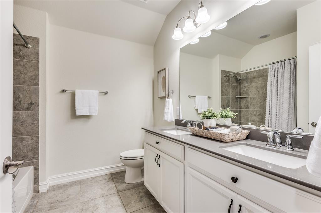 413 Yellowstone Drive Celina, TX 75009 - Photo 19 of 33 a bathroom with a double vanity sink mirror and toilet